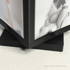 Black photo album with open pages showing a woman and a baby bump.