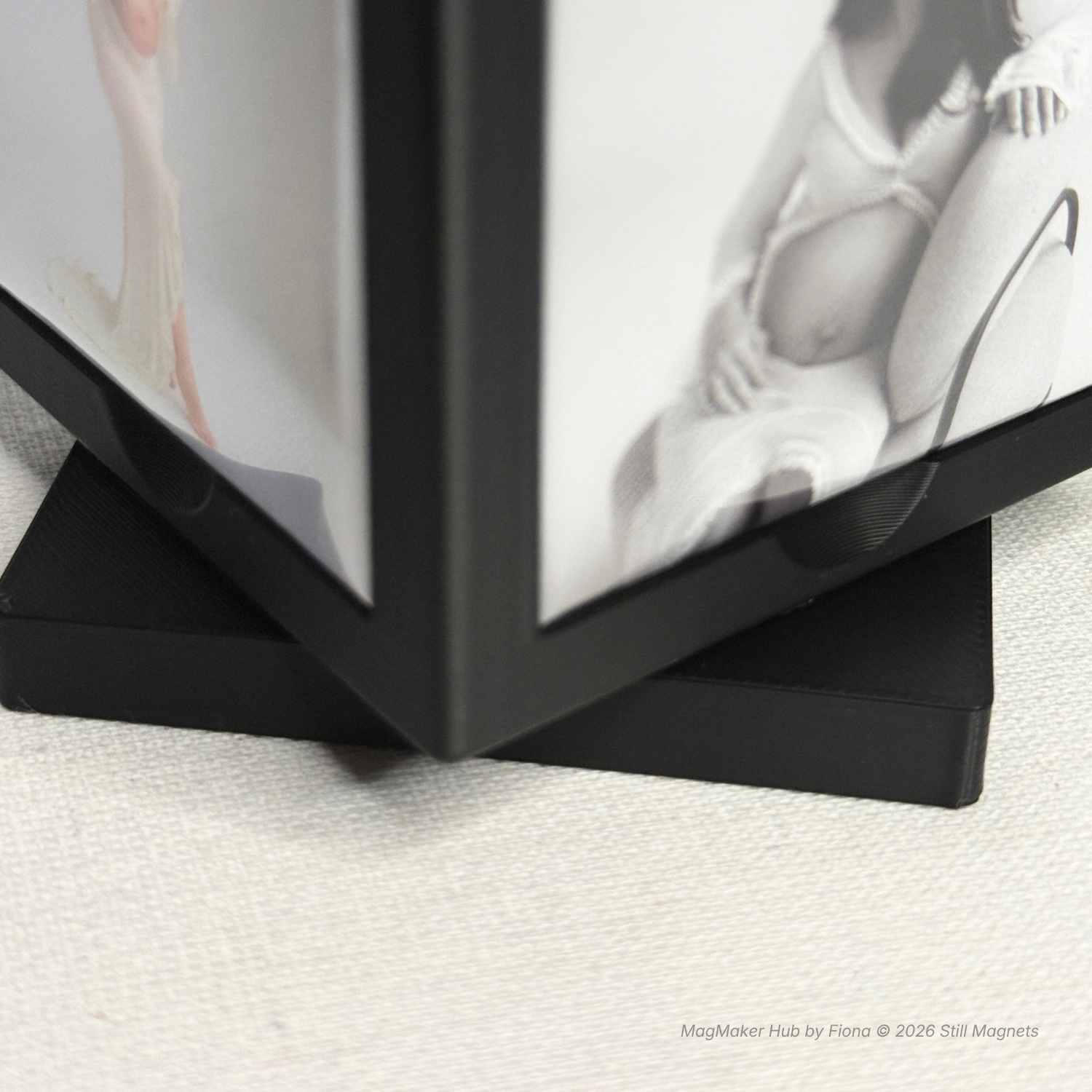 Black photo album with open pages showing a woman and a baby bump.