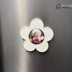 Flower-shaped photo holder with a picture of a baby on a metallic surface