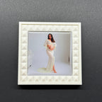 White decorative frame with a photo of a woman on a gray background