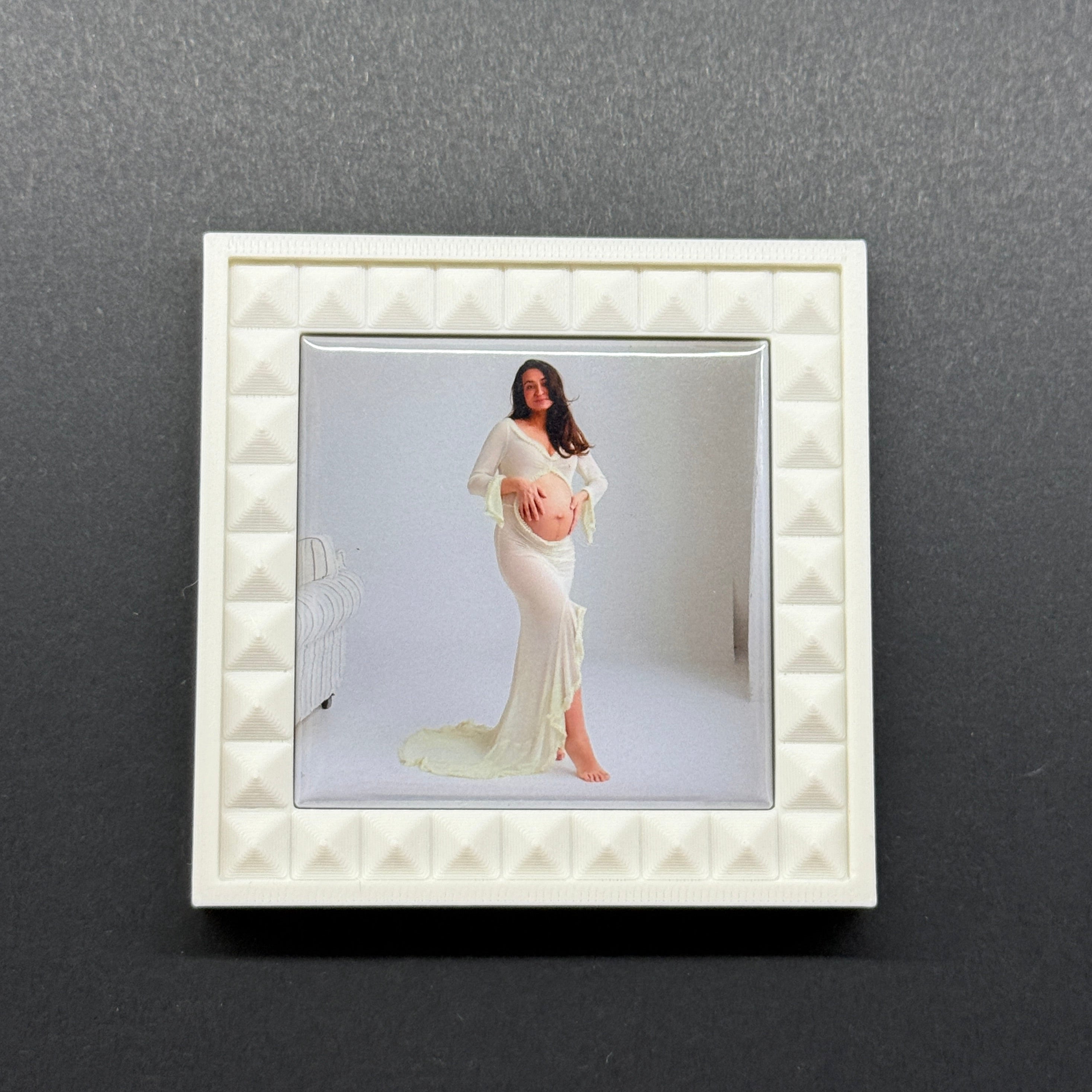 White decorative frame with a photo of a woman on a gray background