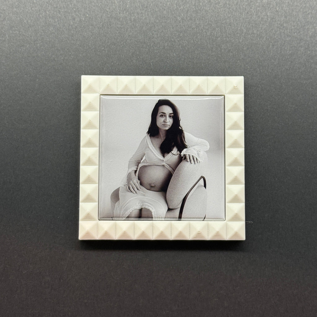 Decorative photo frame with a textured border on a dark gray background