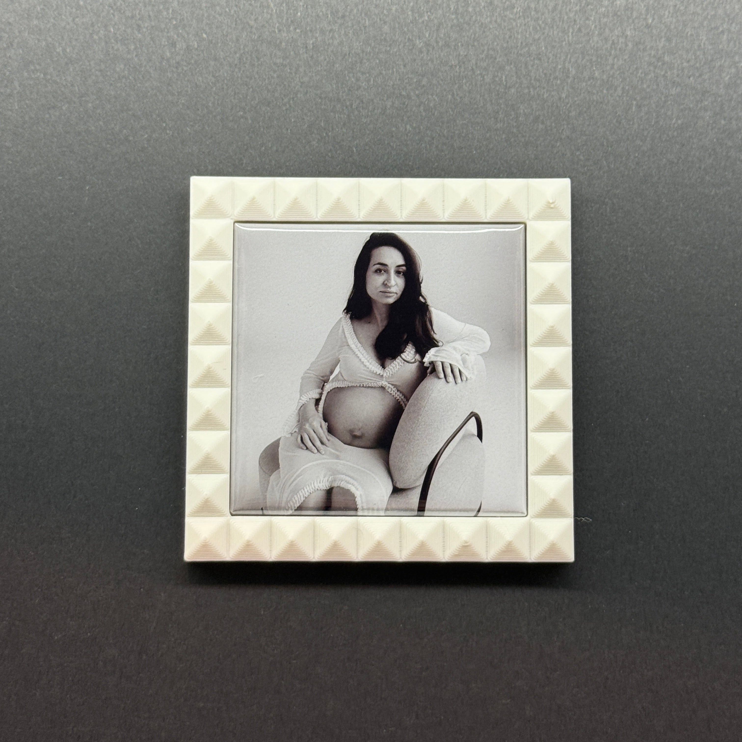 Decorative photo frame with a textured border on a dark gray background