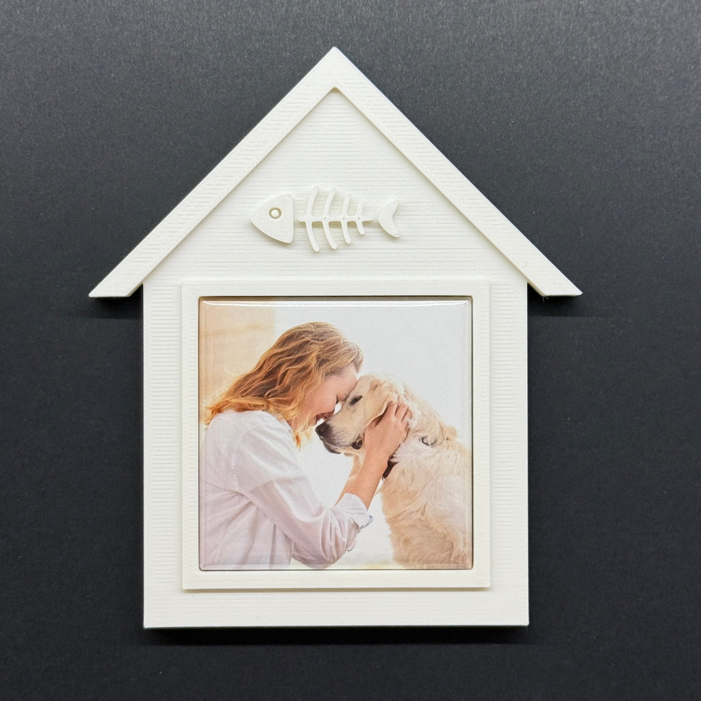 White arrow-shaped photo frame with a picture of a woman and dog on a dark background