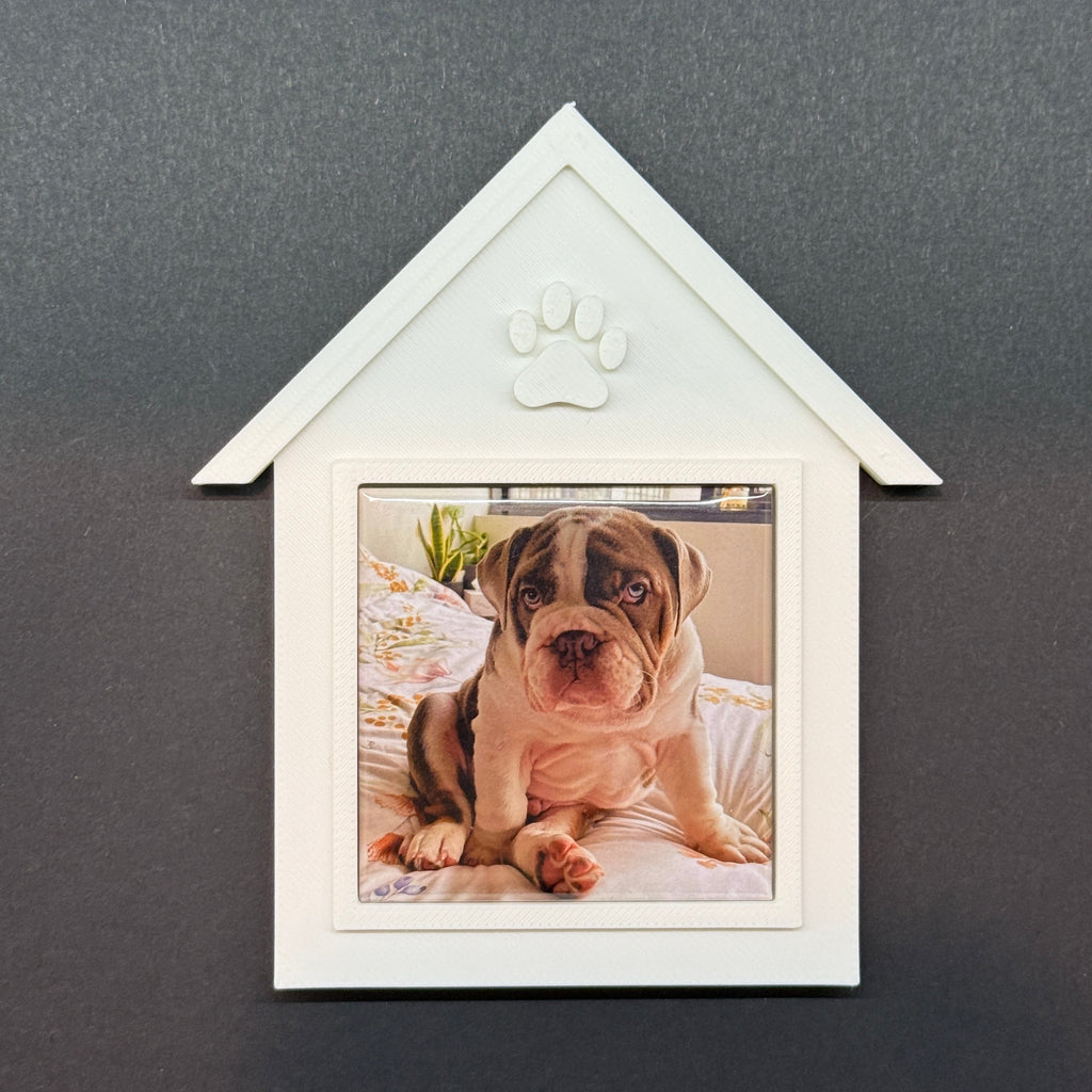 White decorative frame with a photo of a dog on a dark gray background