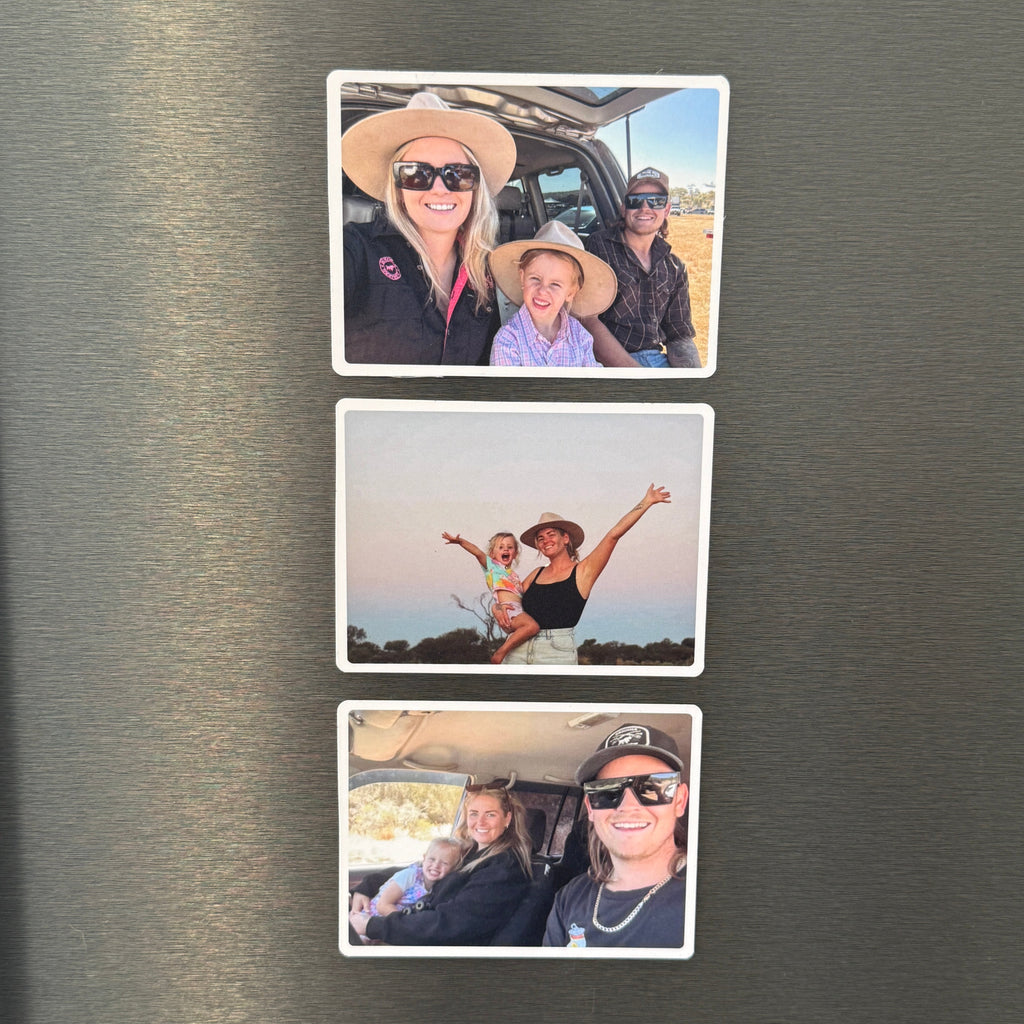 Three rectangular photo magnets with white borders are arranged vertically on a brushed stainless steel refrigerator door. Each magnet shows a different family selfie scene.