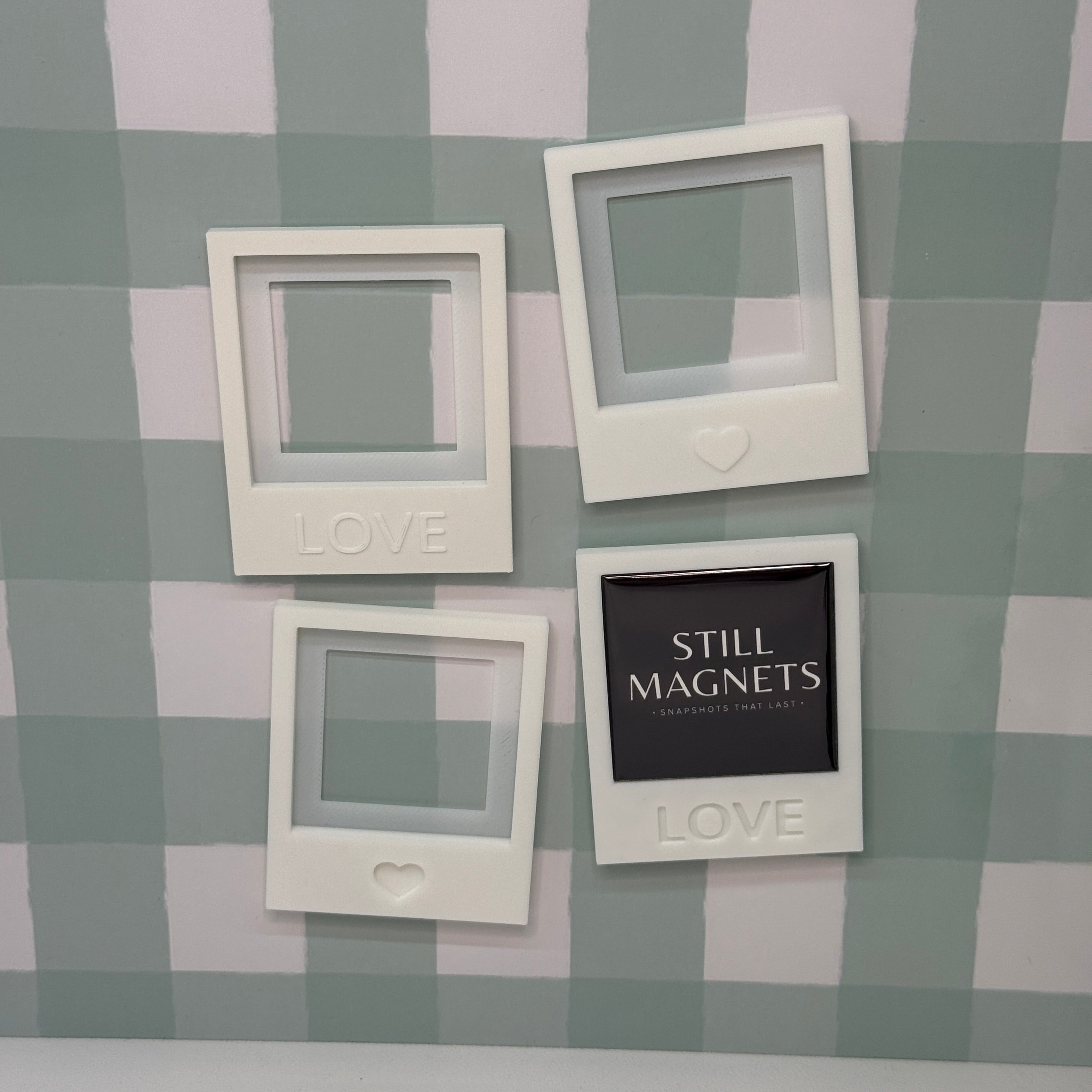 White picture frames with 'LOVE' text on a checkered wall.