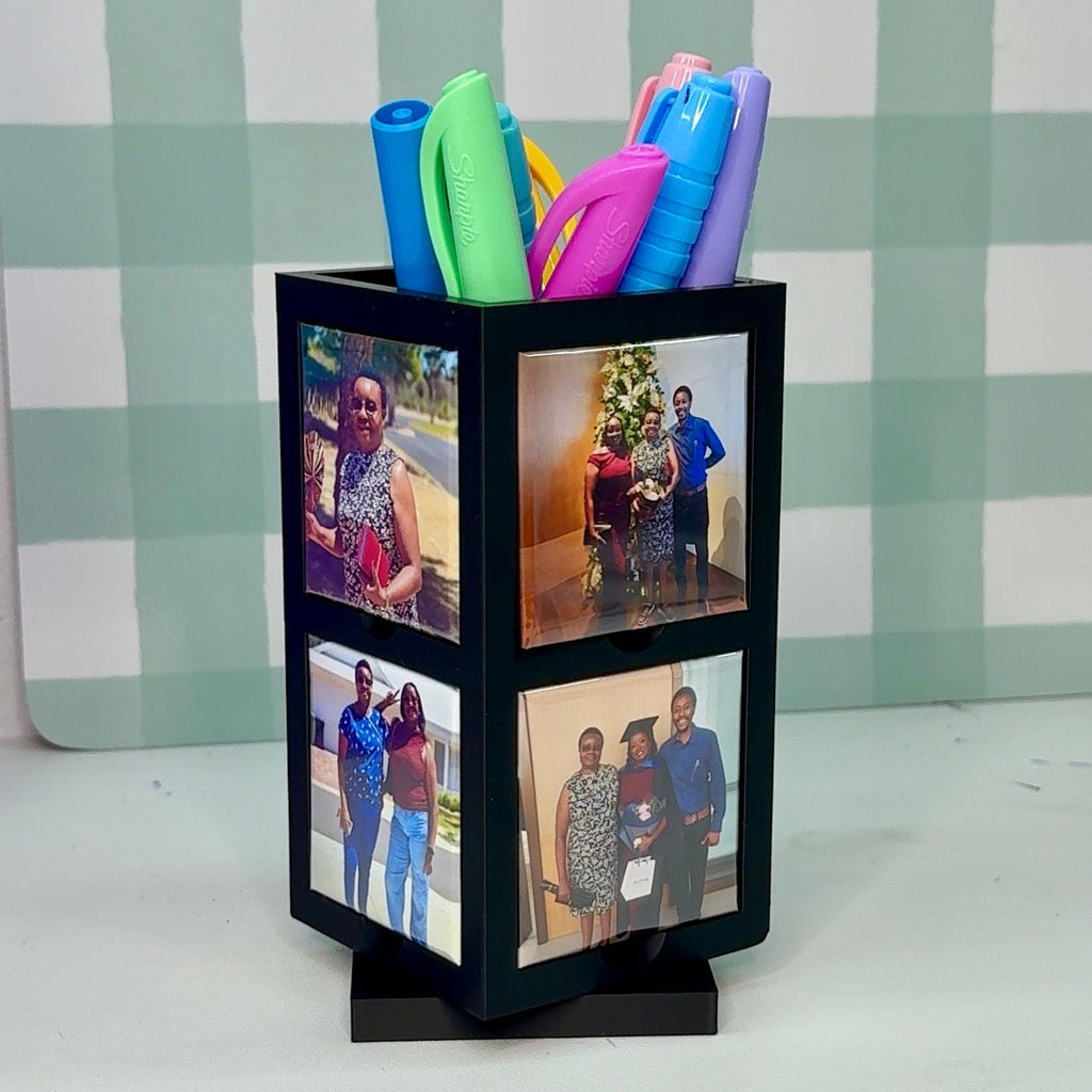 Pencil holder with colorful pens and family photos on a checkered background