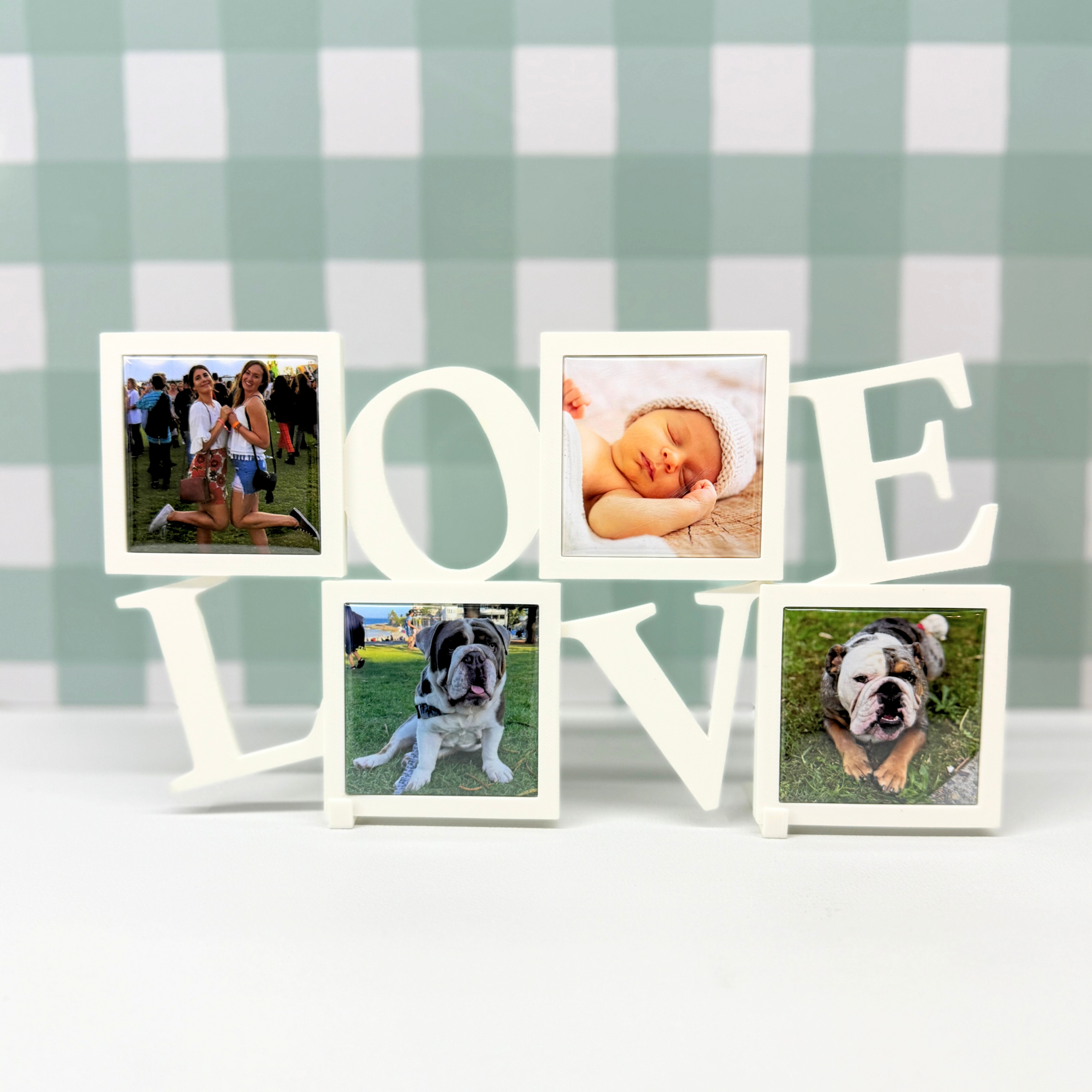 LOVE frame with photo magnet of baby, friend, bulldogs on green checkered background